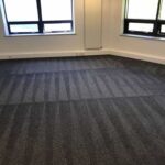 This is a photo of a grey office carpet that has just been professionally steam cleaned works carried out by Buckhurst Hill Carpet Cleaning