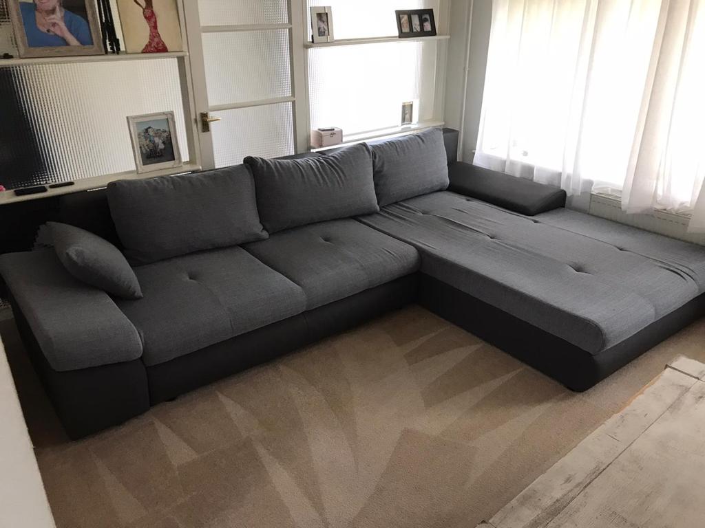 This is a photo of a grey L shape sofa that has been professionally steam cleaned, also the beige carpets have been steam cleaned too works carried out by Buckhurst Hill Carpet Cleaning